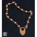 An early 20th Century 9ct rose gold bracelet comprising eighteen shots united by jump rings,