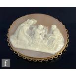 A modern 9ct mounted oval cameo brooch depicting three seated woman and a cherub playing a lyre,