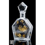 A Baccarat glass decanter, the hexagonal flat section body with gilded decoration of leaves and