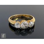 An early 20th Century 18ct diamond three stone ring, old cut claw set stones, total weight