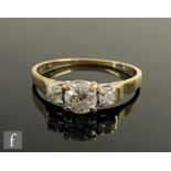 A 9ct hallmarked diamond three stone ring, central brilliant cut stones, approximately 0.65ct,