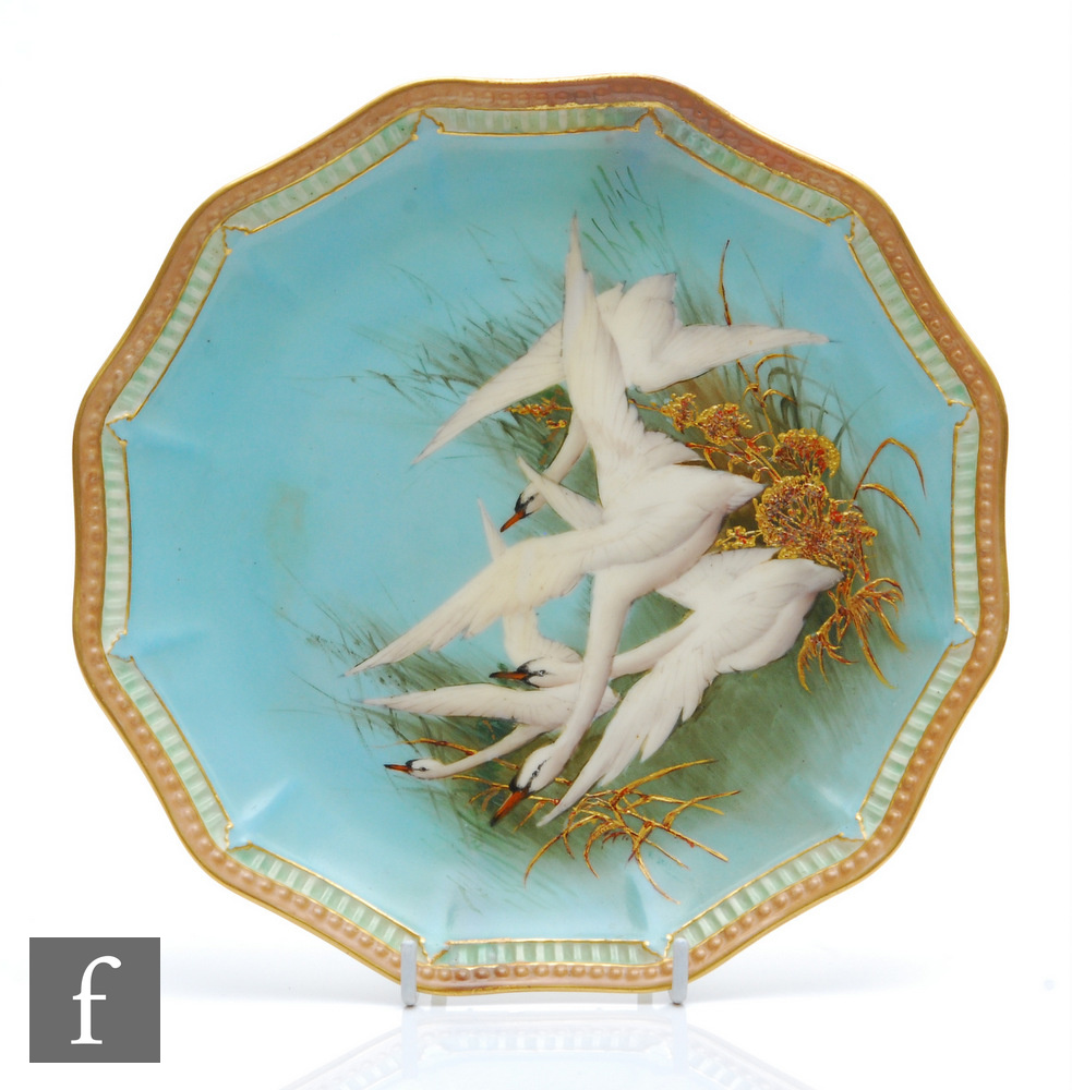 A Royal Worcester cabinet plate decorated by Charlie Baldwin with four hand painted swans in