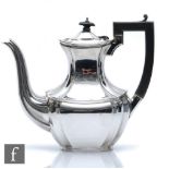 A hallmarked silver Queen Anne style coffee pot of plain form with scroll wooden handle, weight