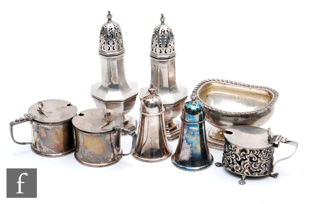 Eight assorted hallmarked silver condiments to include two pairs of peppers, two drum mustard pots