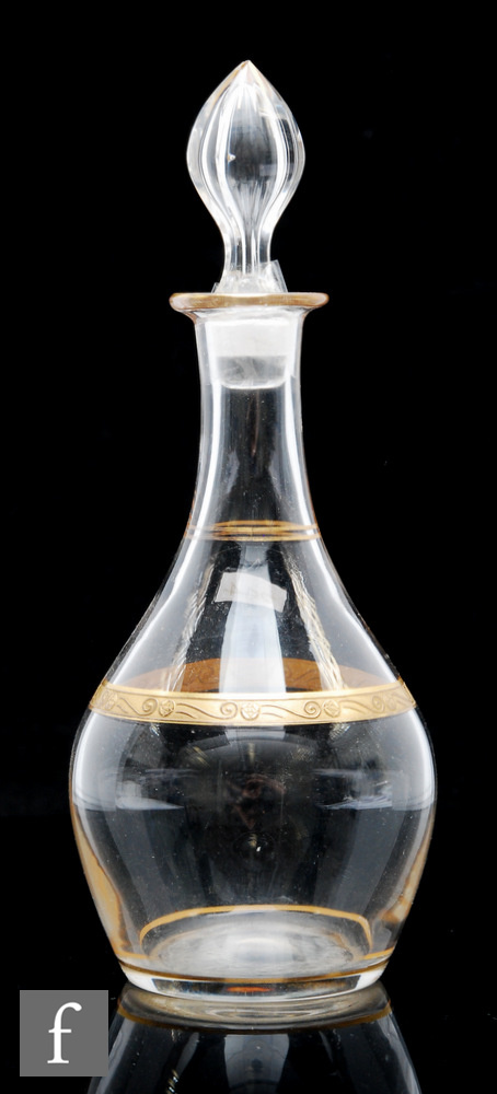 A Bohemian glass liqueur decanter, circa 1900, of baluster form, the body with a gilded band