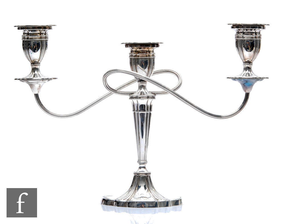 A hallmarked silver three light candelabra, shaped oval base below fluted column, twin reeded arms