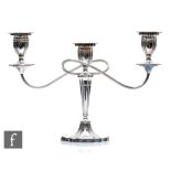 A hallmarked silver three light candelabra, shaped oval base below fluted column, twin reeded arms