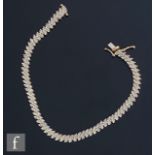 A modern diamond set flexible bracelet comprising pairs of brilliant cut stones, weight 10.5g,