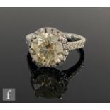A platinum diamond halo ring, central claw set brilliant cut stones, weight approximately 3.20ct,