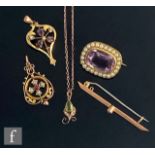 A small parcel lot of late 19th Century jewellery to include two 9ct open work pendants, a diamond
