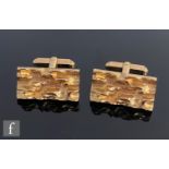 A cased pair of 9ct hallmarked rectangular swivel cufflinks each with a rough molten effect, total
