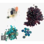 A parcel lot of assorted loose stones to include garnets, matrix and other turquoise, moonstone,