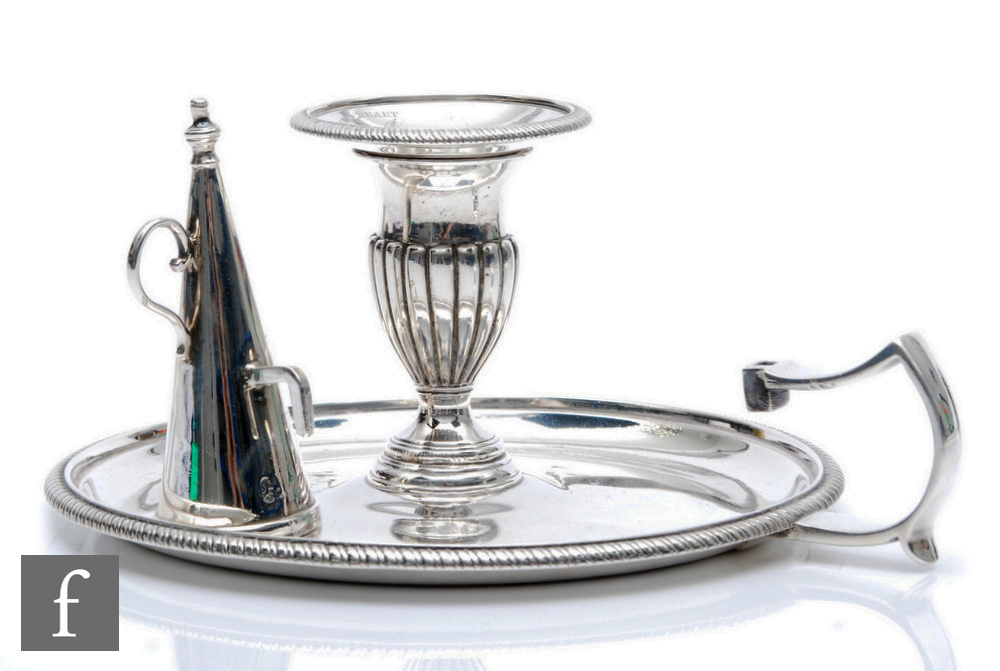 A Georgian hallmarked silver chamber stick and associated snuffer, beaded border and engraved crests