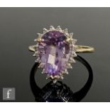 A 9ct hallmarked amethyst and diamond cluster ring, central marquise amethyst, length 15.5mm, claw