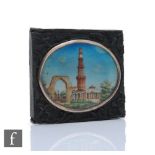 A 19th Century Indian School oval miniature depicting temple ruins, width 5cm, to a hard wood
