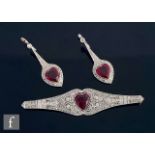 An 18ct white gold ruby and diamond earrings and brooch set, each with a single heart shaped ruby to