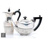 A hallmarked silver bachelor's boat shaped teapot with a similar hot water pot, total weight 14.5oz,
