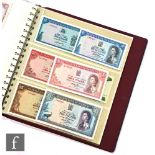 An album of world banknotes to include Malta, St Helena, Mauritius, New Zealand, Solomon Island
