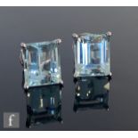 A pair of 18ct white gold aquamarine stud earrings, emerald cut claw set stones each approximately