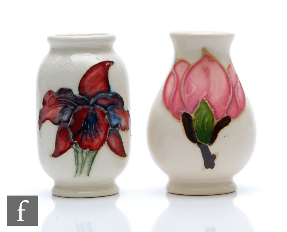 Two miniature Moorcroft vases, the first of barrel form decorated in the Orchid pattern, the