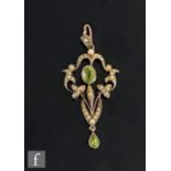 An early 20th Century 9ct peridot and seed pearl set open work pendant, weight 3g, length 5cm.