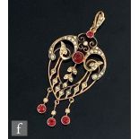An Edwardian 9ct red paste stone and seed pearl open work pendant, weight 4.7g, length 6.5cm,