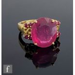 An 18ct hallmarked ruby ring, claw set central stone, length 13.5mm, with four further rubies set to