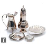 Five items of hallmarked silver, a cream jug, a sugar castor, a butter dish, a pin dish and a host