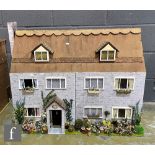 A 1970s dolls house modelled as The Farmhouse, three storey including attic, eight rooms, hinged
