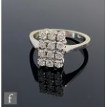 An 18ct hallmarked white gold diamond floodlight ring comprising three vertical rows of four