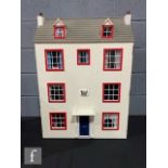 A dolls house modelled as a Georgian style house, three storey and attic, eight rooms, hinged