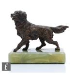 A bronze study of a standing spaniel mounted to a green onyx rectangular base, length 11cm, S/D.