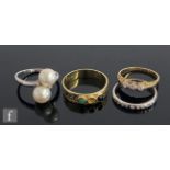 Three 14ct stone set rings to include a two stone pearl, a diamond three stone and a multi stone