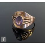 A 9ct single stone amethyst ring, oval collar set stones to strut shoulders and a wide head,