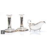 A pair of hallmarked silver piano candlesticks with ribbon and swag decoration to columns, height