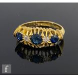 An early 20th Century 18ct hallmarked sapphire and diamond five stone boat shaped ring, weight 3.3g,