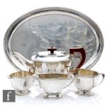 An Art Deco style hallmarked silver pedestal  boat shaped three piece tea set of plain form with