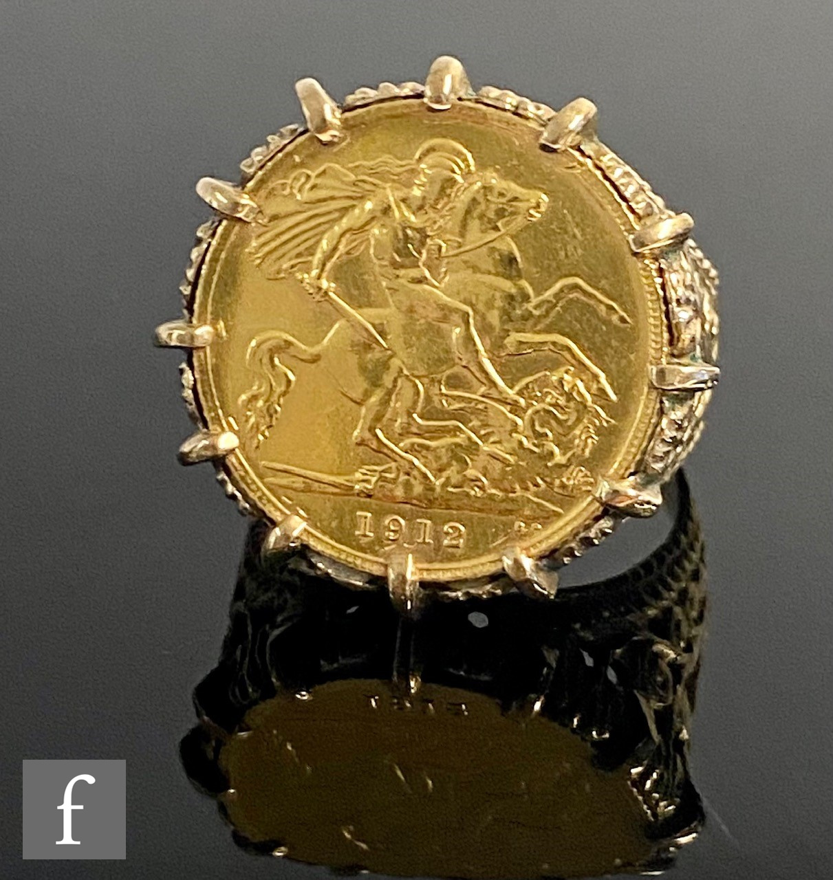 A George V half sovereign ring with pierced shoulders, coin dated 1912, weight 10.2g.g.