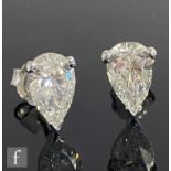 A pair of 18ct white gold pear shaped, claw set diamond stud earrings, each approximately 1.50ct,