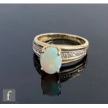 A 9ct hallmarked opal and diamond set ring, high set opal to diamond set shoulders, weight 2.8g,