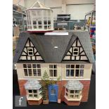 A dolls house modelled as The Black and White House, two storey plus attic, six rooms plus