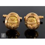 A pair of continental 18ct swivel cufflinks each with a scarab beetle design to front within a plain