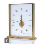A Jaeger Le Coultre skeleton clock within twin glass panels and brushed gilt frame, height 20cm, S/