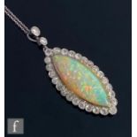 An 18ct white gold opal and diamond pendant, collar set central marquise opal, length 3cm, within