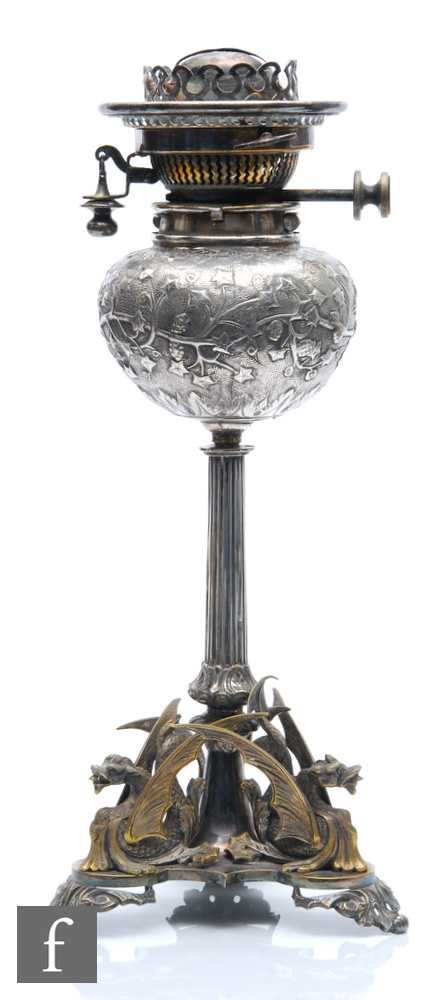 A late 19th Century silver plated oil lamp in the manner of Elkington & Co, the triform griffin