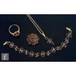 An 8ct garnet bracelet comprising of seven four stone set panels, with a matching pendant and