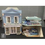Two dolls houses, the first modelled as a toy shop, Thomas's Tots and Toys, two storey, hinged