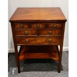 A contemporary Reprodux mahogany canteen table, with hinged fold-over top and three drawers,