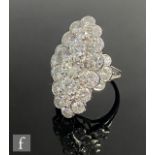An 18ct white gold marquise shaped diamond cluster ring, comprising twenty five individually set