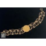 A 9ct hallmarked bracelet, central loose mounted full sovereign dated 1976 flanked by three